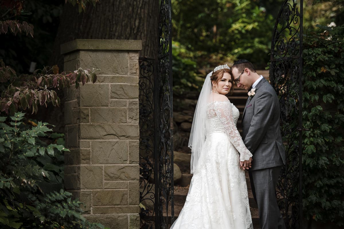 Bride and groom by the gate at Cleveland Botanical Garden