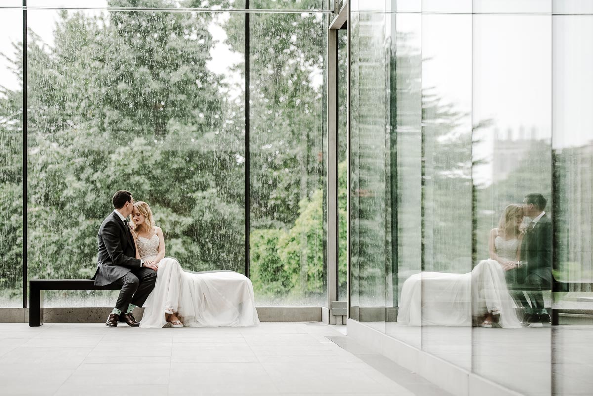 Glass atrium at the art museum with a groom and bride