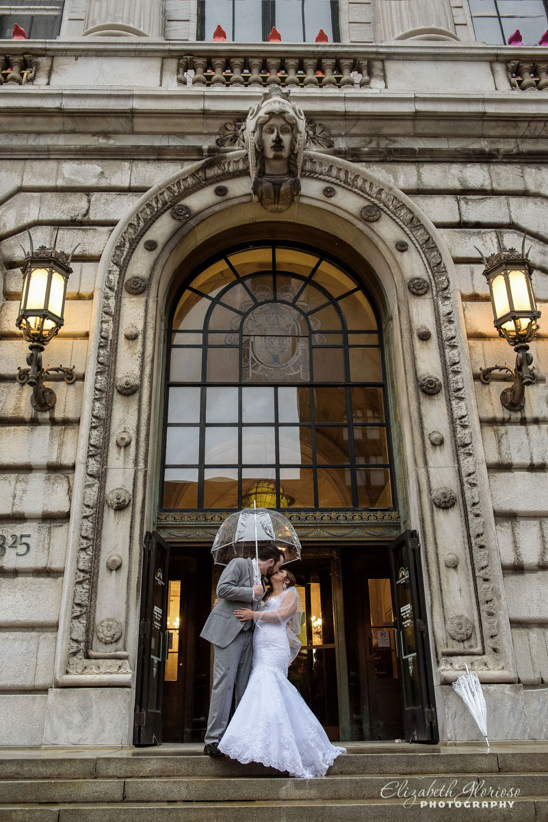 Photo of bride and groom kissing outside of the Cleveland Public Library