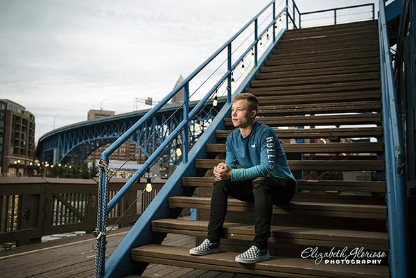 Senior portrait of teen boy sitting on stairs in downtown Cleveland